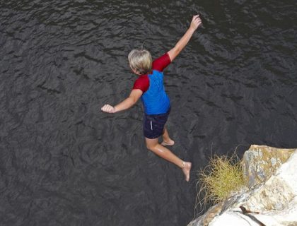 Mark jumping into a rock pool